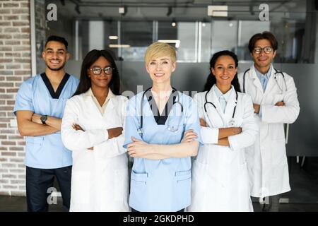 Friendly multiracial doctors team posing at hospital Stock Photo