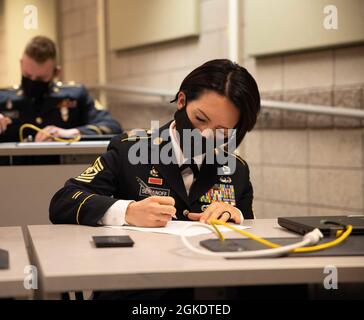 1st Sgt. Tina Semanoff, company first sergeant for Headquarters and Headquarters Detachment, 97th Troop Command, takes a  written exam during the Utah National Guard Best Warrior Competition at Camp Williams, Utah, March 24, 2021. Soldiers representing the Utah National Guard’s major commands will endure intense mental and physical tests over a three-day competition to determine the state’s Soldier of the Year, Non-commissioned Officer of the Year and Senior NCO of the Year. Stock Photo