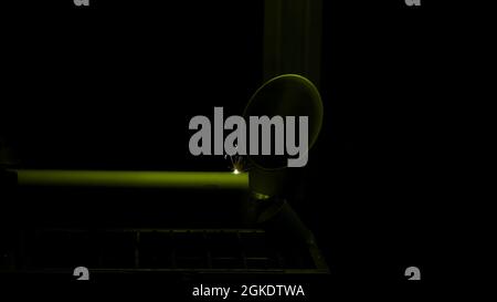 Close up of the CNC laser cutting machine cutting holes in a small tube. HDR. Modern metal manufacturing process Stock Photo