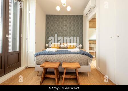 Sleeping area with king size bed in a newly decorated and furnished vacation rental studio Stock Photo