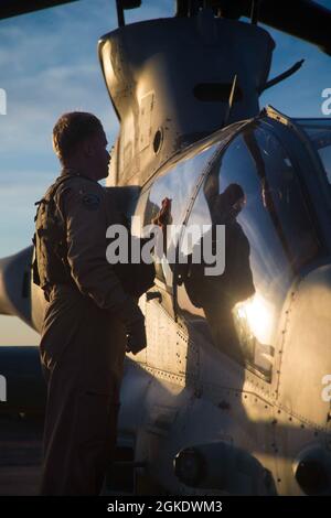 U.S. Marine Corps Capt. Matthew Martin, assigned to Marine Light Attack Helicopter Squadron 369, Marine Aircraft Group 39, 3rd Marine Aircraft Wing, inspects an AH-1Z Viper aircraft, before takeoff in support of Weapons and Tactics Instructor (WTI) course 2-21, at Auxiliary Airfield II, near Yuma, Ariz., March 24, 2021. The WTI course is a seven-week training event hosted by Marine Aviation Weapons and Tactics Squadron One, providing standardized advanced tactical training and certification of unit instructor qualifications to support Marine aviation training and readiness, and assists in deve
