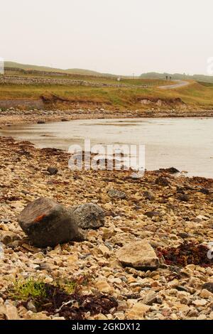 A view of the stoney beach at low tide near Keoldale farm, Kyle of Durness, Sutherland, Scotland Stock Photo