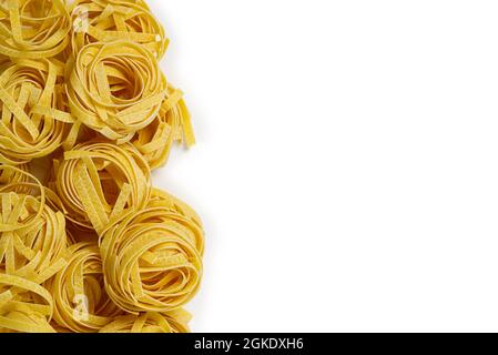 Fettuccine italian pasta isolated on white background. Raw tagliatelle nests isolated on white background. Traditional Italian pasta Stock Photo