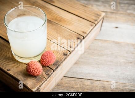 Old fashioned lychee cocktail on the rustic background. Selective focus. Shallow depth of field. Stock Photo