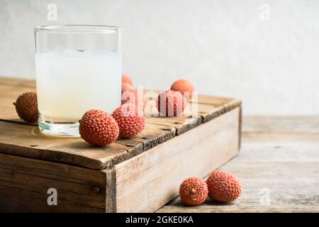 Old fashioned lychee cocktail on the rustic background. Selective focus. Shallow depth of field. Stock Photo