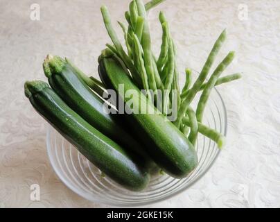 Horticulture on the balcony, home grown harvested zucchini and green beans Stock Photo