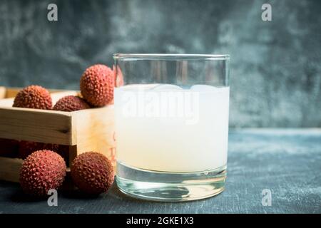 Old fashioned lychee cocktail on the rustic background. Selective focus. Shallow depth of field. Stock Photo