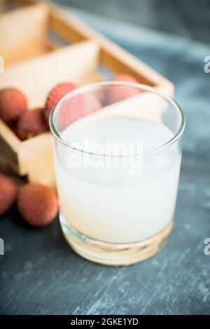 Old fashioned lychee cocktail on the rustic background. Selective focus. Shallow depth of field. Stock Photo