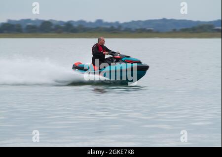 Jet skiing at The Strood, the causeway that connects Mersea Island to the mainland in Essex Stock Photo