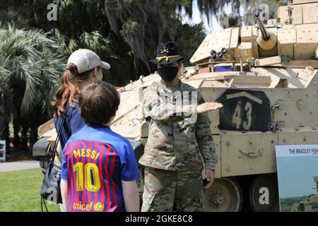 U.S. Army Pfc. Richard Rodriguez, a cavalry scout assigned to the 6th Squadron, 8th Cavalry Regiment, 2nd Armored Brigade Combat Team, 3rd Infantry Division, describes how the M2 Bradley Fighting Vehicle operates, at the Deer Creek Course at The Landings Club, Savannah, Georgia, March 27, 2021. Civilians were encouraged to climb inside the static displays and ask Soldiers questions.