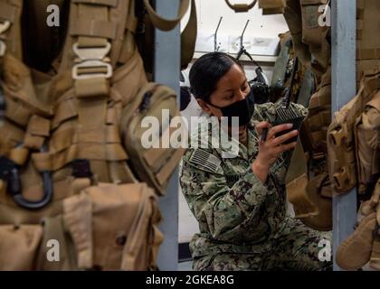 210329-N-PH222-1011 NAVAL AIR STATION FALLON, Nev. (Mar. 29,2021)        Aircrew Survival Equipmentman 2nd Class Vanessa Thomas, from San Diego, assigned to the “Black Knights” of Helicopter Sea Combat (HSC) Squadron 4, inspects aircrew survival gear in the aircrew survival equipmentman shop at Naval Air Station (NAS) Fallon. Air Wing Fallon is part of the predeployment training cycle for Navy's carrier air wings.  HSC-4, along with VFA-2, VFA-192, VFA-113, VFA-147, VAQ-136, VAW-113, and HSM-78 comprise CVW-2 and are detached to NAS Fallon in order to sharpen their warfighting readiness throug Stock Photo