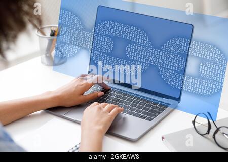 Unrecognizable black business woman typing on laptop, programming and protecting data Stock Photo