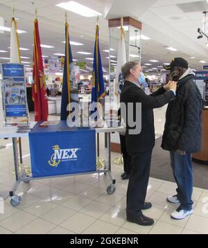 NEX Annapolis, Maryland, honored Vietnam War Veterans with a lapel pin on March 29, National Vietnam War Veterans Day. The Navy Exchange Service Command (NEXCOM) is comprised of 14,000 personnel worldwide facilitating six business lines, NEX retail stores, the Navy Lodge Program, Telecommunications Program, Navy Clothing and Textile Research Facility, Ships Store Program and the Uniform Program Management Office. Stock Photo