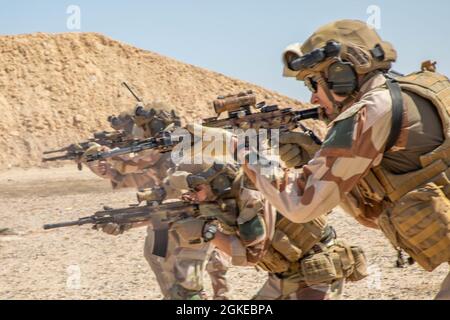 Task Force Viking Soldiers conduct specialized line fire weapon training to be proficient on their weapons in the fight to counter Daesh, outside of Al Asad Air Base, Iraq on a shooting range on March 29, 2021. Specialized weapons and vehicle training is done to be proficient on weaponry and vehicles issued to soldiers in the fight to counter Daesh. Stock Photo