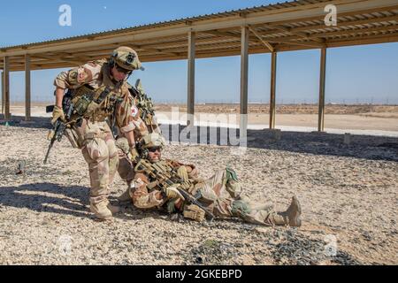 Task Force Viking Soldiers conduct care under fire training to able to conduct care under fire, and proficient on their weapons in the fight to counter Daesh, outside of Al Asad Air Base, Iraq on a shooting range on March 29, 2021. Specialized weapons and vehicle training is done to be proficient on weaponry and vehicles issued to soldiers in the fight to counter Daesh. Stock Photo