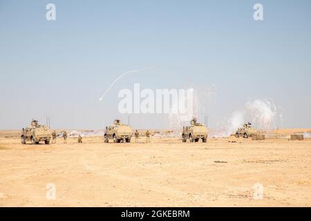 Task Force Viking Soldiers conduct specialized vehicle firing training by firing smoke to be proficient on their weapons in the fight to counter Daesh, outside of Al Asad Air Base, Iraq on a shooting range on March 29, 2021. Specialized weapons and vehicle training is done to be proficient on weaponry and vehicles issued to soldiers in the fight to counter Daesh. Stock Photo