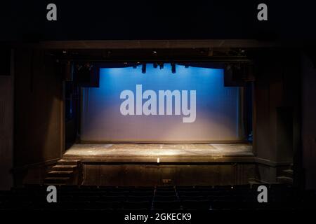Empty Stage Lit in Blue and Yellow Lights on Cyclorama Stock Photo