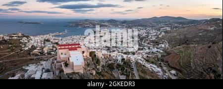 Aerial view of the church Agios Giorgios, view from Ano Syros to houses of Ermoupoli, Anastasi church in the evening light, sea with islands, Ano Stock Photo