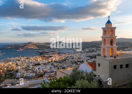 View from Ano Syros to houses of Ermoupoli, church in evening light, sea with islands, Ano Syros, Syros, Cyclades, Greece Stock Photo