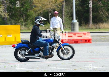 A student participates in a riding exercise while Eric Kruizenga, an instructor with American Motorcycle Training, observes during the Basic RiderCourse on Corry Station, March 30. Free, specialized motorcycle training provided by American Motorcycle Training is available onboard NAS Pensacola for active duty personnel who desire to ride. Stock Photo