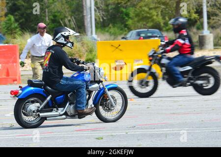 Students participate in a riding exercise while Eric Kruizenga, an instructor with American Motorcycle Training, observes during the Basic RiderCourse on Corry Station, March 30. The Basic RiderCourse is required for active duty Sailors who desire to operate a motorcycle. Stock Photo