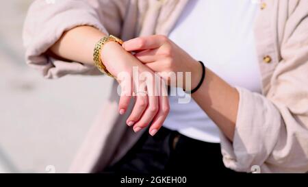 A woman is setting her watch Stock Photo