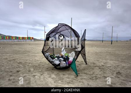 El Dorado, Peru - July 30, 2021: Waste bin shaped as a fish located on beach Stock Photo