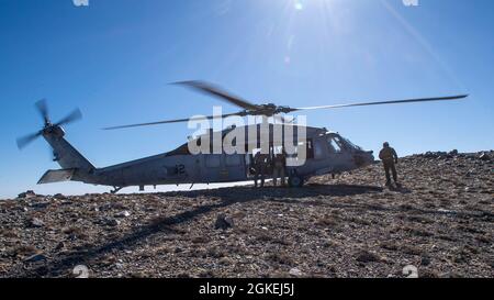 210331-N-PH222-1160 Fallon, Nev. (Mar. 31, 2021)        A MH-60S Knighthawk helicopter attached to the “Black Knights” of Helicopter Sea Combat (HSC) Squadron 4, prepares for take-off during a high-altitude landing training evolution hosted by Naval Aviation Warfighting Development Center at Naval Air Station (NAS) Fallon. The Navy Mountain Flying Course trains pilots and aircrew for challenges associated with flying the aircraft to its limitations in higher density altitudes and power management of the aircraft in this environment. Air Wing Fallon is part of the predeployment training cycle f Stock Photo