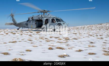 210331-N-PH222-1422 Fallon, Nev. (Mar. 31, 2021)        A MH-60S Knighthawk helicopter attached to the “Black Knights” of Helicopter Sea Combat (HSC) Squadron 4, prepares for take-off during a high-altitude landing training evolution hosted by Naval Aviation Warfighting Development Center at Naval Air Station (NAS) Fallon. The Navy Mountain Flying Course trains pilots and aircrew for challenges associated with flying the aircraft to its limitations in higher density altitudes and power management of the aircraft in this environment. Air Wing Fallon is part of the predeployment training cycle f Stock Photo