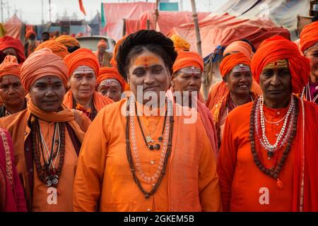 Sadhvi in orange and red saree during Allahabad Kumbh Mela, the largest religious gathering in the world, Uttar Pradesh, India Stock Photo