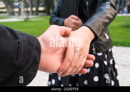 A woman shakes hands with a client at a business meeting with a tablet in her hands Stock Photo