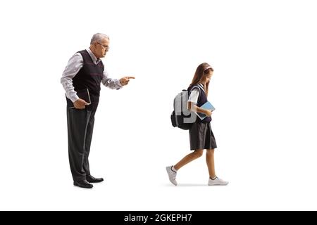 Male teacher reprimending a female pupil in a school uniform walking and holding a book isolated on white background Stock Photo