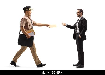 Full length profile shot of a mailman giving a letter to a businessman isolated on white background Stock Photo