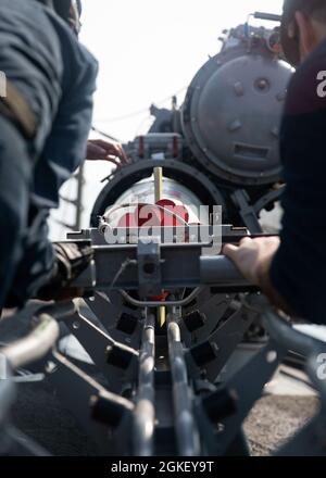 A Mk 46 torpedo is deployed from an SH-2F Sea Sprite helicopter ...