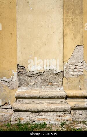 Old plastered weathered street wall background. Architectural detail. Stock Photo