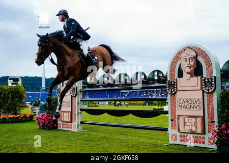 Aachen, Germany. 14th Sep, 2021. Equestrian sport/jumping: CHIO, Youngsters Cup. The rider Ben Maher from Great Britain on the horse Point Break jumps an obstacle. Credit: Uwe Anspach/dpa/Alamy Live News Stock Photo