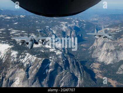Two F-15C Eagles from the 144th Fighter Wing fly in formation with a KC-135 Stratotanker from Fairchild Air Force Base during operation Noble Defender over California, April 6, 2021. Noble Defender simulated air defense of ports in California and North Carolina. Stock Photo