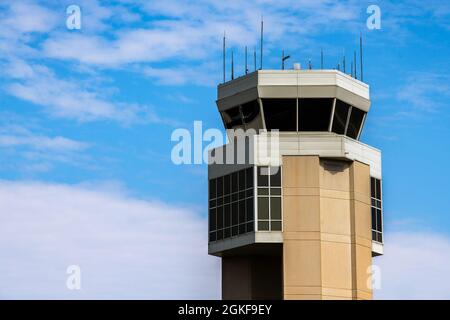 The air traffic control tower keeps watch over the flight line at Dover Air Force Base, Delaware, April 7, 2021. The 436th Airlift Wing is home to the Department of Defense’s “Super Port”, C-17A Globemaster IIIs and the C-5M Super Galaxy. Stock Photo