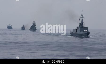 210407-M-JX780-1039 BAY OF BENGAL (April 7, 2021) – French Navy La Fayette-class frigate, FS Surcouf (F711), leads a tactical evolution of Australian, Indian, and Japanese ships through the Bay of Bengal during La Perouse 2021. La Perouse is an exercise during the annual French Navy midshipman deployment called Mission Jeanne d'Arc. The exercise is designed to conduct training, enhance cooperation in maritime surveillance, maritime interdiction operations, and air operations. Stock Photo