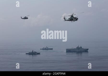 210407-M-JX780-1776 BAY OF BENGAL (April 7, 2021) – Clockwise, from top left, an Australian Royal Navy MH-60 Sea Hawk and a U.S. Marine Corps AH-1Z Viper assigned to Marine Medium Tiltrotor Squadron 164 (Reinforced), 15th Marine Expeditionary Unit, fly over the French Navy ship, FS Tonnerre (L9014), French Navy La Fayette-class frigate, Surcouf (F711), and Australian Royal Navy ship, HMAS Anzac (FFH 150), while the ships maneuver in formation through the Bay of Bengal during La Perouse 2021. The amphibious transport dock ship USS Somerset (LPD 25) is part of the Makin Island Amphibious Ready G