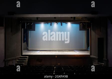 Empty Stage Lit in Blue Lights on Cyclorama and Yellow Spotlights Stock Photo