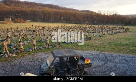 Soldiers attending Air Assault School are put through a round of Y-squats during bag layout at Fort Indiantown Gap on April 8, 2021. Air Assault School is a 10-day course designed to prepare Soldiers for insertion, evacuation, and pathfinder missions that call for the use of multipurpose transportation and assault helicopters. Stock Photo