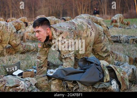 A Soldier attending Air Assault School at Fort Indiantown Gap completes 'mountain climbers' during bag layout on April 8, 2021. Air Assault School is a 10-day course designed to prepare Soldiers for insertion, evacuation, and pathfinder missions that call for the use of multipurpose transportation and assault helicopters. Stock Photo