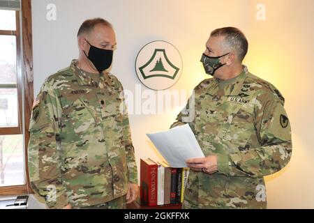 Garrison Commander Col. Michael Poss (right) congratulates Deputy Garrison Commander Lt. Col. Alexander Carter on April 8, 2021, after learning that Carter was been selected for promotion to colonel (O-6) at Garrison Headquarters at Fort McCoy. Being selected for O-6, Carter now has further leadership and command opportunities open to him. Stock Photo