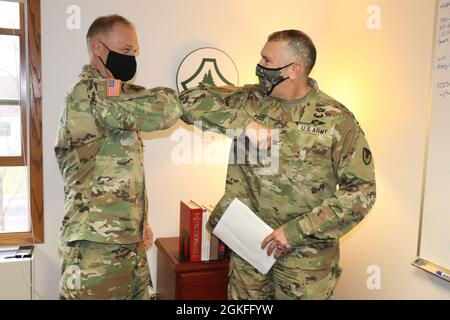 Garrison Commander Col. Michael Poss (right) congratulates Deputy Garrison Commander Lt. Col. Alexander Carter on April 8, 2021, after learning that Carter was been selected for promotion to colonel (O-6) at Garrison Headquarters at Fort McCoy. Being selected for O-6, Carter now has further leadership and command opportunities open to him. Stock Photo