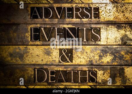 Adverse Events And Deaths text on textured grunge copper and vintage gold background Stock Photo