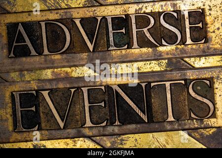 Adverse Events text on textured grunge copper and vintage gold background Stock Photo
