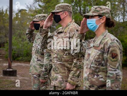 2nd Combat Weather Systems Squadron leadership salutes U.S. Air Force Lt. Gen. Timothy Haugh, commander of 16th Air Force (Air Forces Cyber), during his visit at Hurlburt Field, Florida, April 9, 2021. This visit allowed 2nd CWSS leadership to showcase their mission and create a line of communication directly between the geographically separated squadron and the Sixteenth Air Force. Stock Photo