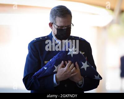 Maj. Gen. Michael T. McGuire holds the American flag presented to him during his retirement ceremony April 10, 2021, at Papago Park Military Reservation in Phoenix. McGuire served as Arizona’s adjutant general for eight years and concludes a nearly 34-year military career that began after graduating from the United States Airforce Academy in 1987. (Arizona Army National Guard photos by Sgt. 1st Class Brian A. Barbour) Stock Photo
