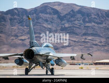 An F-16 fighting falcon taxis out during a training exercise, April 10, 2021 at Nellis Air Force Base, Nev. The 926th AMXS conducted an operations exercise to maintain steadfast readiness that relate to real world day-to-day functions. Stock Photo
